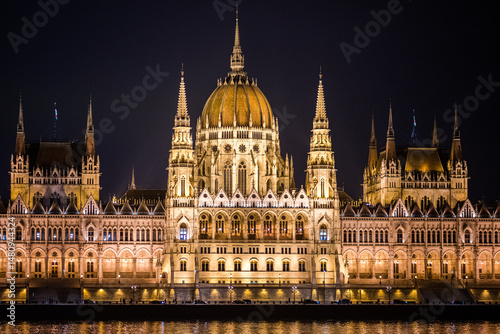 Budapest, Hungary - January 22 2023: The Hungarian Parliament Building (Országház) illuminated at night, reflected in the Danube.