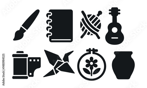 Solid style icons of creative hobbies: painting brush, sketchbook, yarn ball, guitar, film roll, origami, embroidery hoop, clay pot.