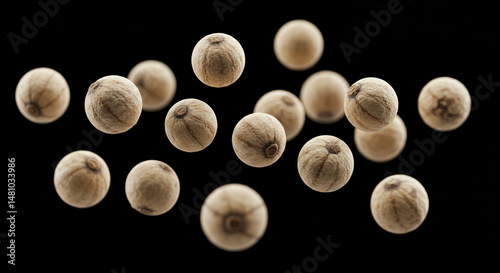 Small, tan, round balls on a black background.
