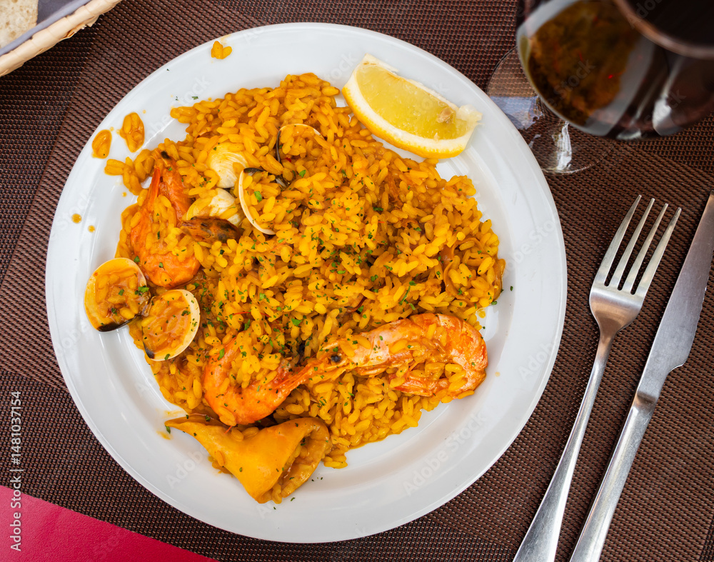Appetizing traditional spanish dish paella with seafood on platter