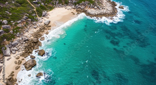 Coastal beach scene representing serenity and escape, featuring turquoise water, rocks, and sandy shoreline