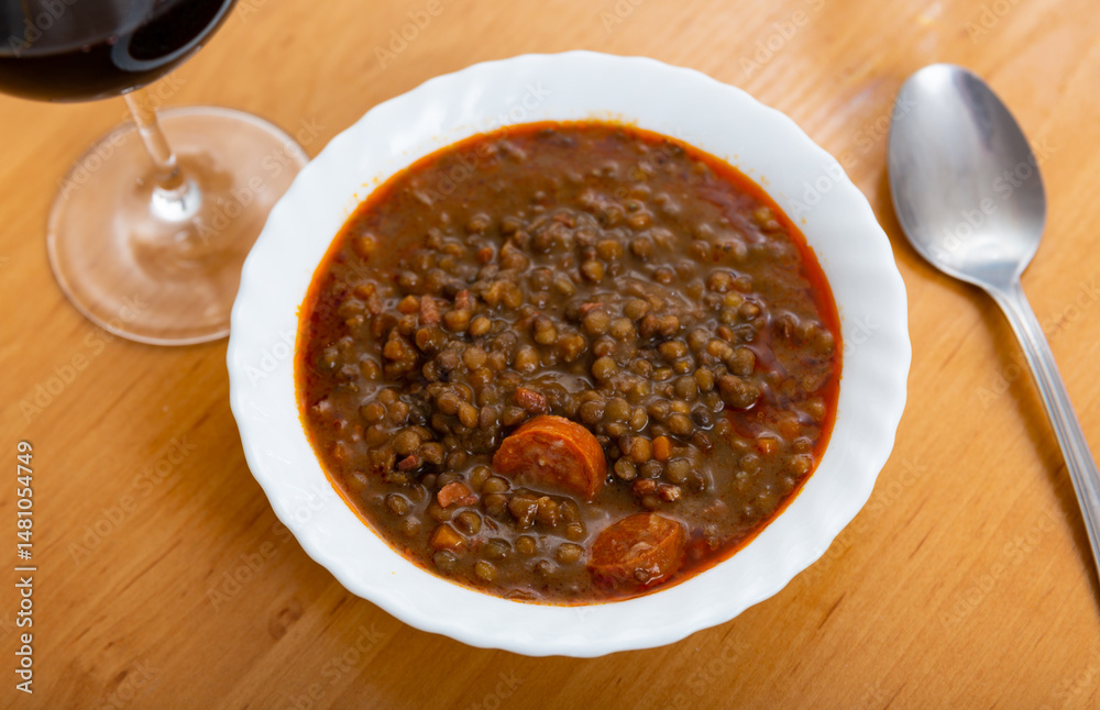 Red lentil soup with carrots and pork pieces is traditional European hot dish for lunch or dinner..