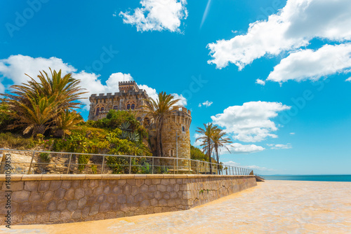 Historic Palacio Estoril Hotel adjacent to Estoril station and Tamariz beach, a picturesque spot for travel brochures and postcards