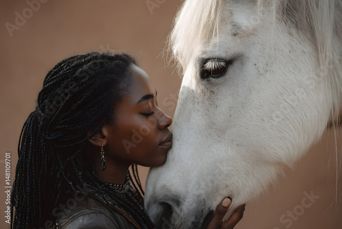 Close-up of woman bonding with white horse through gentle muzzle touch in profile view