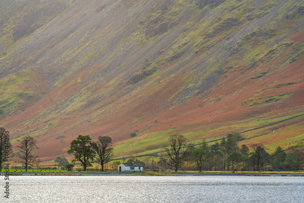 Buttermere lake with white cottage in Lake district. England