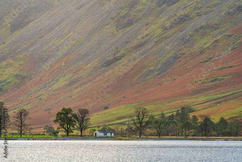 Buttermere lake with white cottage in Lake district. England