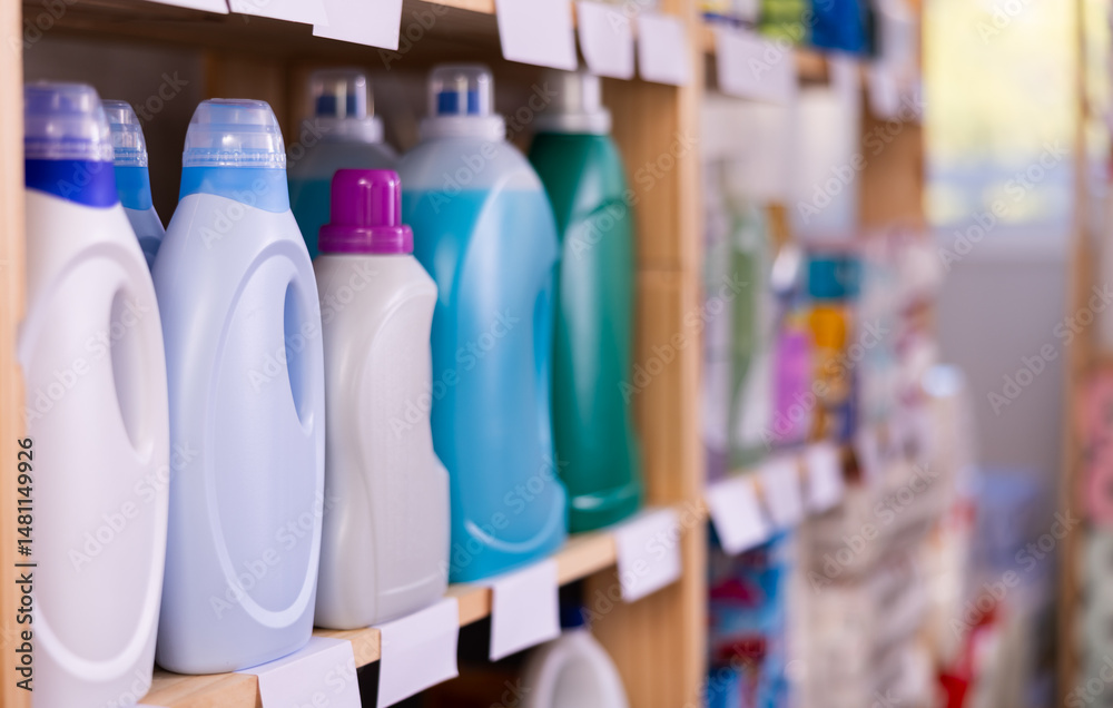 Bottles of laundry detergent displayed on shelves of household chemicals store