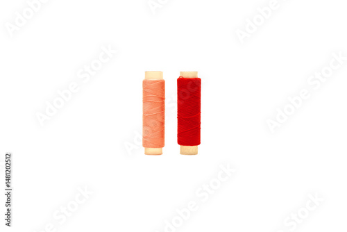 Photos Red spool and Pink spool of sewing thread isolated on white background