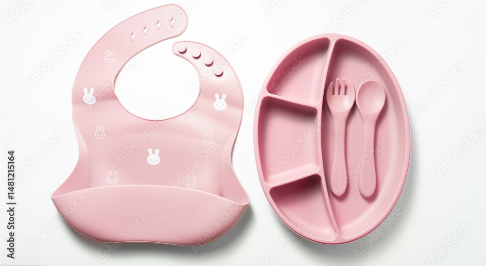 t lay of pink silicone baby feeding set with divided plate, spoon, fork, and bib on white background. Perfect for baby mealtime and toddler weaning. t lay of pink silicone baby feeding set with divided plate, spoon, fork, and bib on white background. Perfect for baby mealtime and toddler weaning.