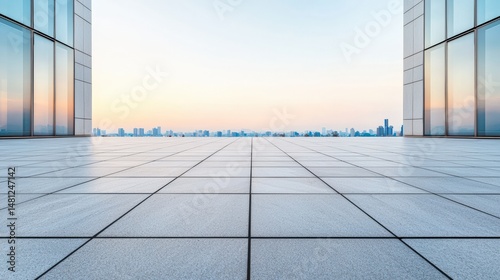 Fototapeta Naklejka Na Ścianę i Meble -  Modern urban plaza showcasing sleek tiles and city skyline at sunset