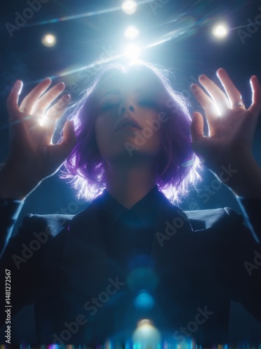 Photograph of hands and head, dark room with blue light rays from the top, a ...