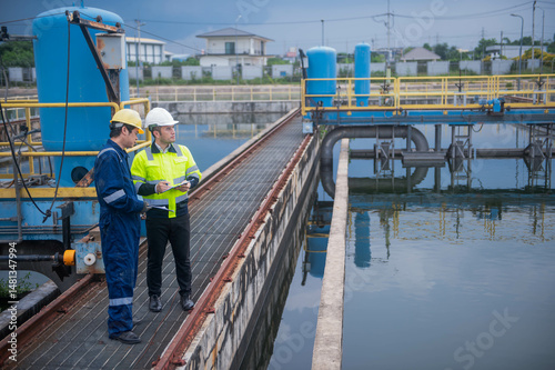 An inspector and an engineer at a water treatment plant are working together to plan the installation of additional water filters to make the water cleaner and safe for household use.
