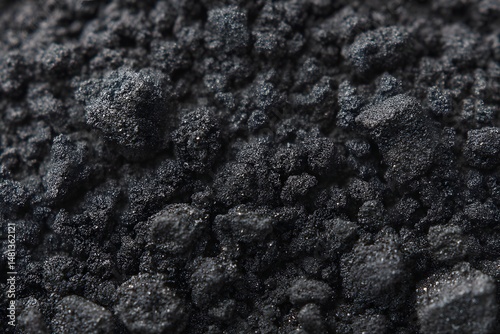 Texture of Black Powder: A macro shot reveals a detailed texture of finely ground black powder, the focus emphasizes depth and detail of each individual grain.