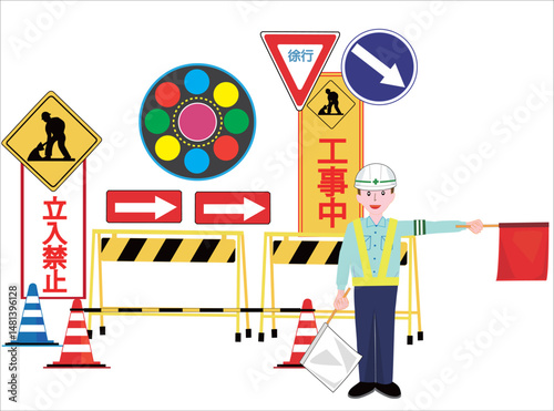 工事現場で交通誘導員が車に注意を促している。