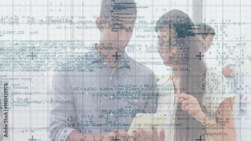 Wallpaper Mural Male holding tablet and female pointing with stylus on screen in tech office, with code overlay Torontodigital.ca