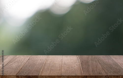 Empty wood table top and blur of restaurant background selective focus product display