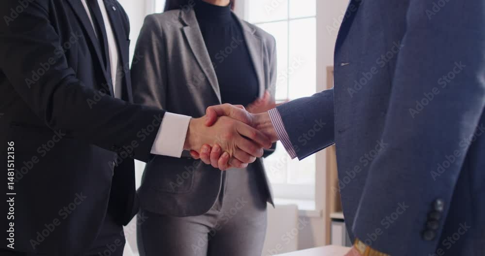 Happy business people in formal suit making a deal shaking hands with partners standing at desk in office during meeting. Company employees applauding colleagues. 4k video. Slow motion video.