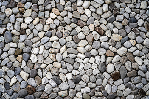 Embossed stones on cement wall for abstract background and texture for interior or exterior design. Beautiful patterns, space for work, banner, wallpaper close up. photo