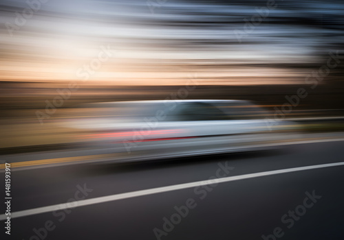 Blurred car sunset road