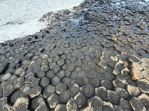 The Giant's Causeway, a UNESCO World Heritage Site on Northern Ireland's Antrim Coast, features 40,000 interlocking basalt columns formed by volcanic activity. Its hexagonal stones and coastal beauty 