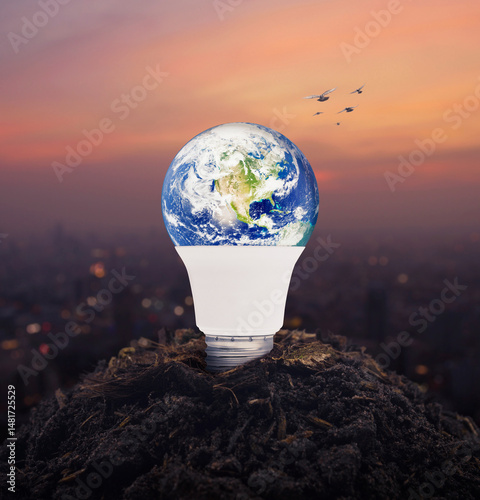 Fototapeta Naklejka Na Ścianę i Meble -  Earth globe inside led light bulb on soil over blur of cityscape on warm light sundown, Ecology saving power and energy concept, Elements of this image furnished by NASA