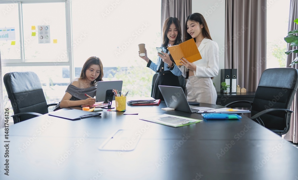 Fototapeta premium group of business people collaborating new project in office asian business woman team meeting discuss ideas Three female entrepreneurs.
