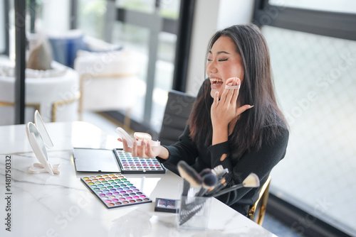 Asian girl makeup artist Professional Woman blogger vlogger is showing cosmetics products with recording video Beauty influencer asian girl video online marketing.