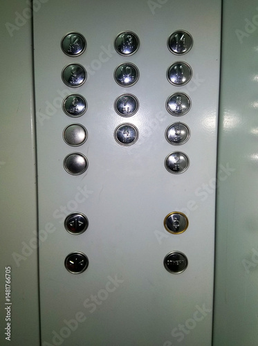 A white elevator with buttons on the wall.