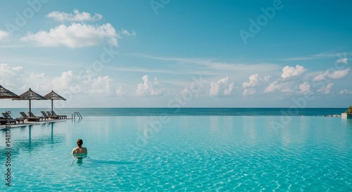 Photo of Woman Relaxing in Infinity Pool Overlooking Tropical Ocean