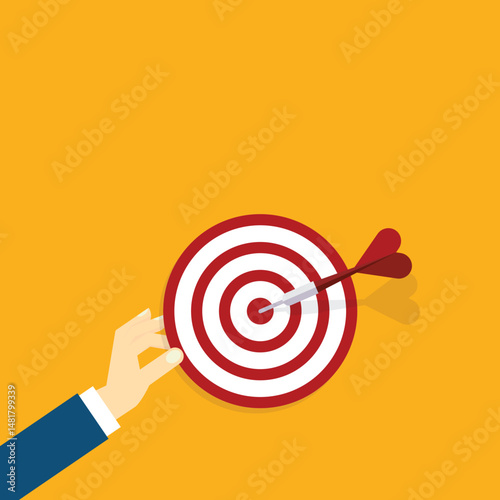 Hand holding a target, showing a goal. Red arrow hits the center. Business challenge failure and success concept.