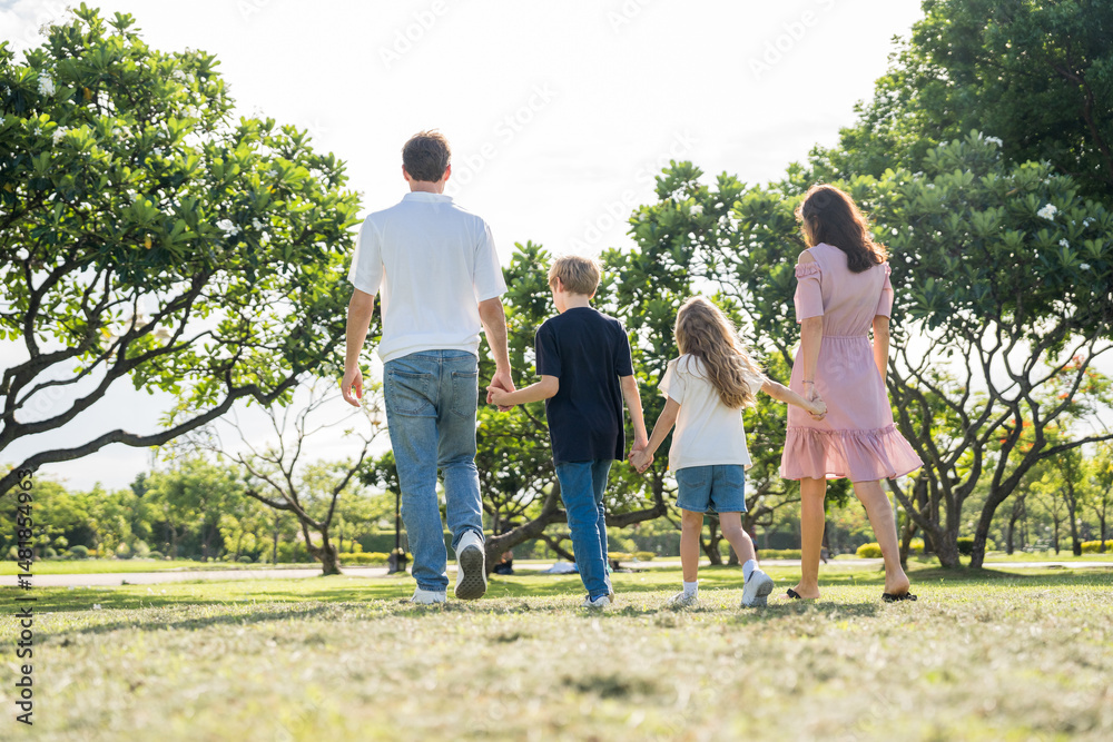 Fototapeta premium Happy family parent children having picnic outdoor activity. Enjoy happiness moment summer playing together including father mother son and daughter relaxing in the morning sunrise.
