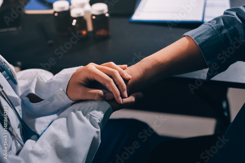 Murais de parede female doctor or woman medical staff holding hand, working hand in hand, giving
