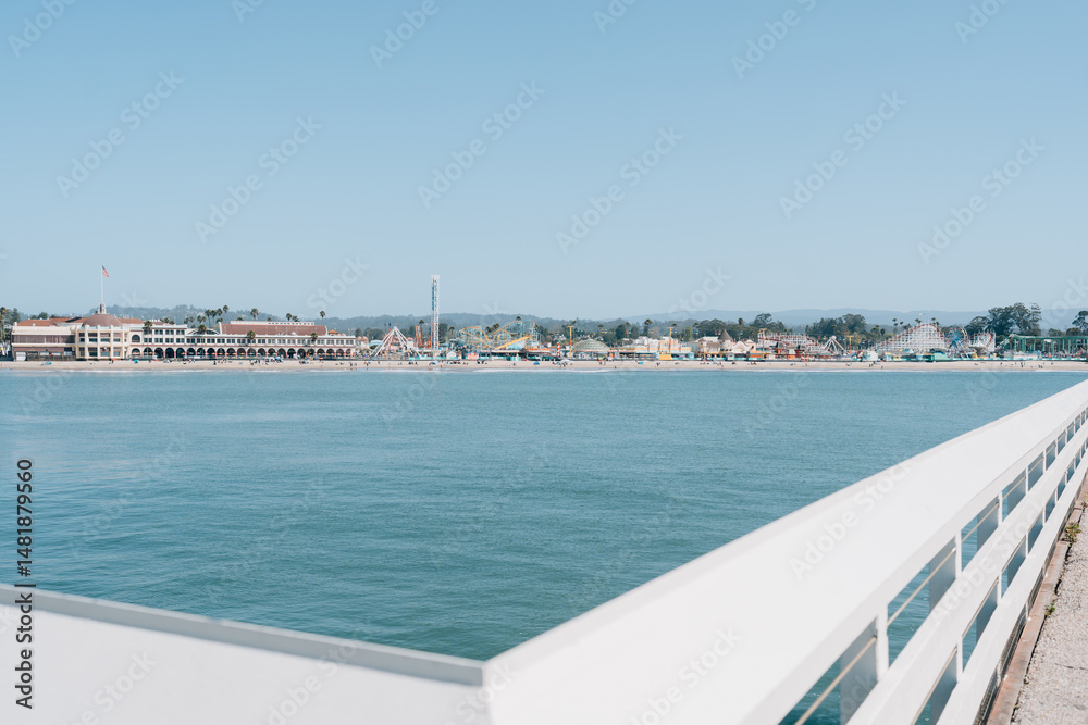 Fototapeta premium Amusement park view from the pier across the bay