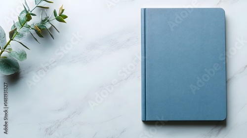 Blue Textured Hardcover Book Mockup on Marble Surface
