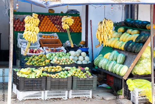 Fototapeta Naklejka Na Ścianę i Meble -  Fresh fruits and vegetables, grocery market in India, sale stall on street with banana, watermelon, apple and oranges, indian culture