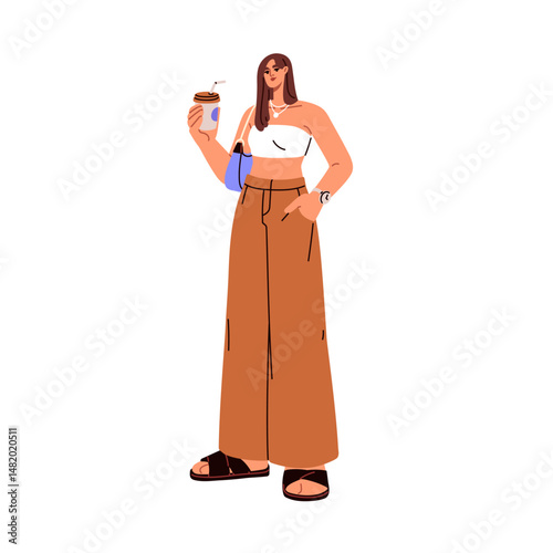 Young woman in fashion outfit with paper cup in hand. Modern style girl in ca...