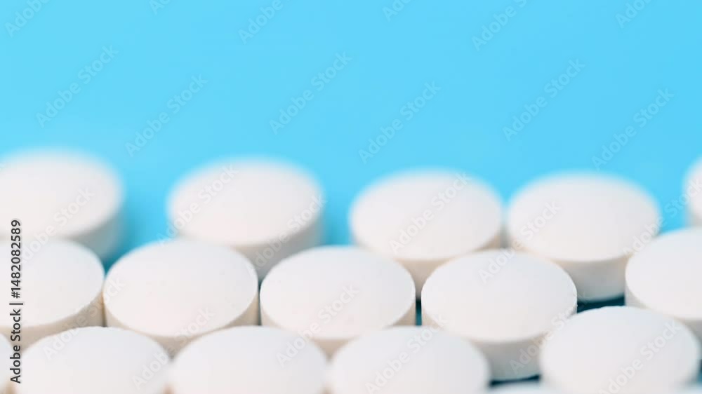 video - white pills on blue background video - white pills on blue background