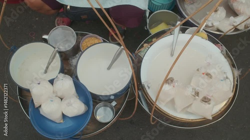 Vermicelli in Coconut Milk (Thai Dessert) - Kanom Pa Grim Kai Tao and Coconut Dumplings in Sweet Coconut Milk with hawker in Phetchaburi, Thailand.