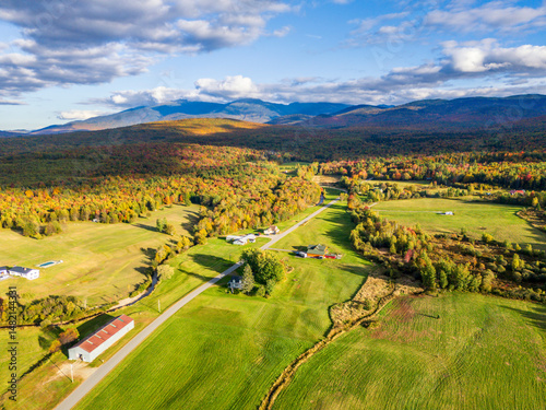 Aerial view of fall foliage in New Hampshire's White Mountain National Forest with Mount Jefferson and Mount Washington in the background photo