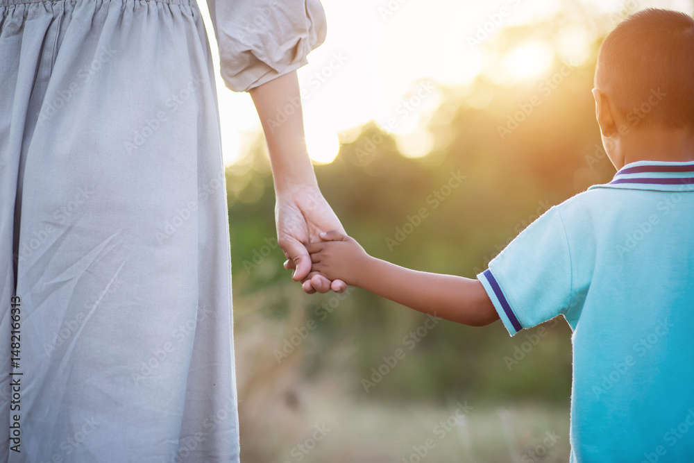 Mother holding a hand of her son Mother holding a hand of her son