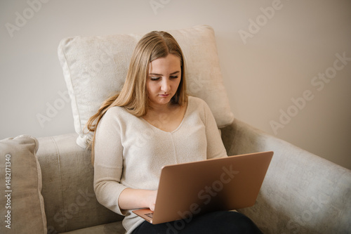 Young busy stressed business trader. Analyst woman looking at laptop monitor feeling tired frustrated reading bad news on financial market working in home. Investor broker analyzing indices.