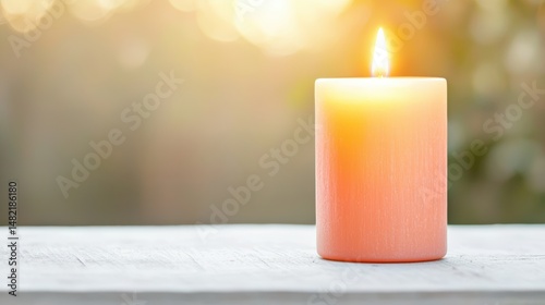 A sun-themed candle glowing softly, warm tones on a white table,