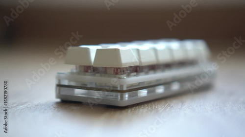 Close-up view of a modern keyboard with white buttons.