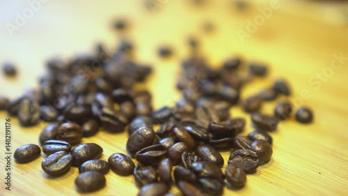 Close-up of roasted coffee beans on a wooden surface