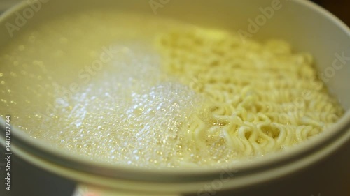 Boiling pasta noodles in a pot on the stove.