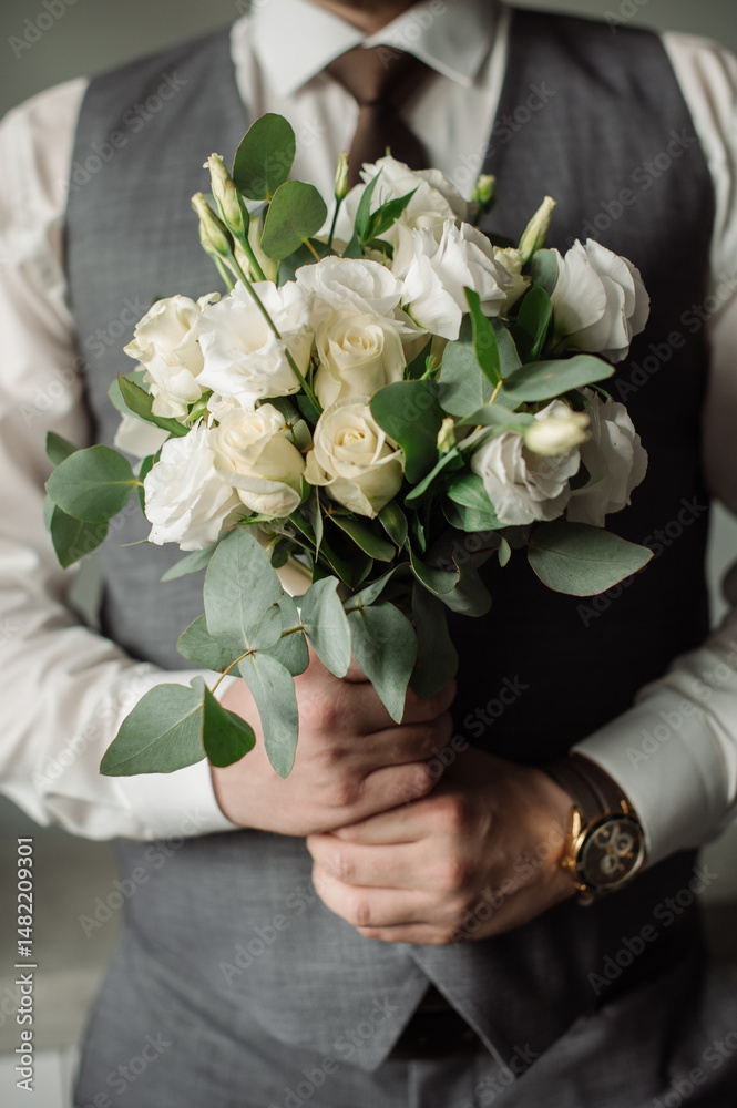 Wedding day. Groom holding a beautiful bouquet Wedding day. Groom holding a beautiful bouquet