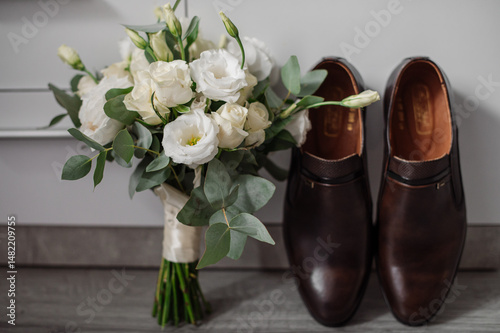 Wedding day. Bouquets and various wedding accessories, shoes, invitations, rings in the morning at the bride's preparation