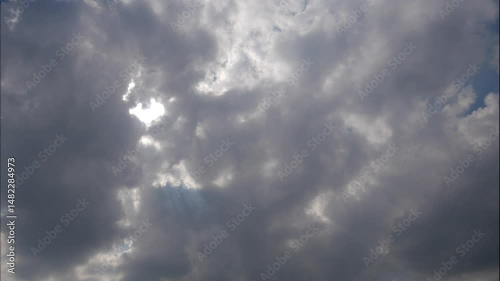 Timelapse of clouds shifting and sunlight breaking through a bright sky Timelapse of clouds shifting and sunlight breaking through a bright sky