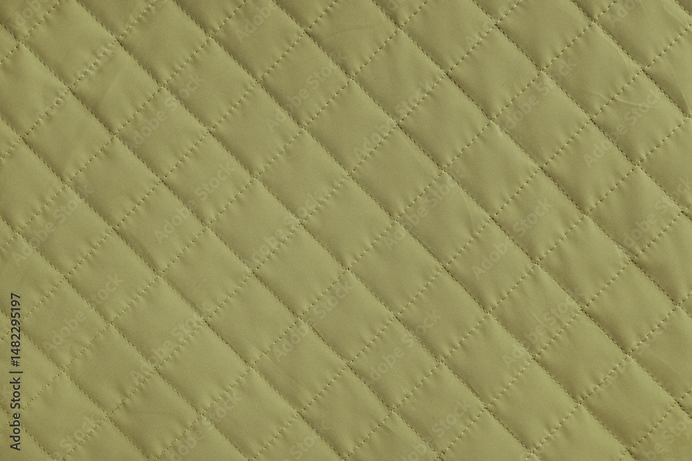 Fototapeta premium Checkered, diamond stitching pattern, khaki quilted fabric background. Blanket or puffer jacket, stitch rhombus texture close up, macro. Wallpaper, backdrop.
