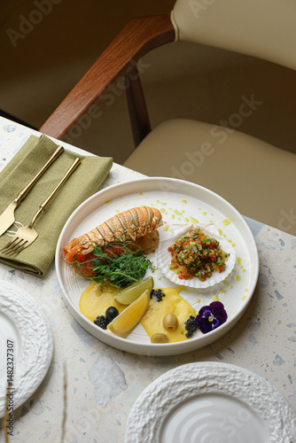Seafood dinner setting with fresh lobster and greens